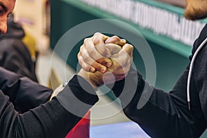 Two men competing in arm wrestling