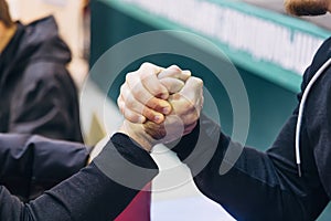 Two men competing in arm wrestling