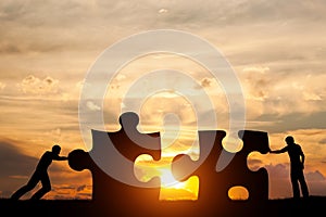 Two men connect two puzzle pieces. Concept of business solution, solving a problem.