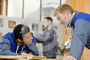two men cooperation in workshop