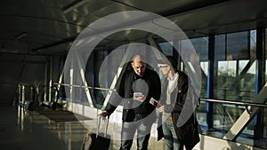 Two men in the corridor of the airport to communicate in anticipation of the start of registration.
