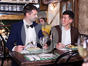 Two men are dinning in luxury restaurante together