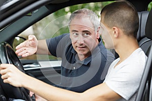 two men discussing work in car