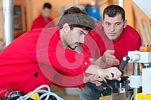 Two men doing factory work