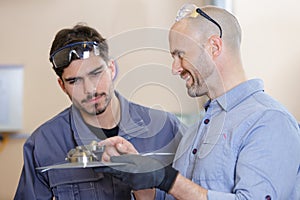 two men doing induction hardening in workshop
