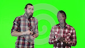 Two men eating french fries on green screen
