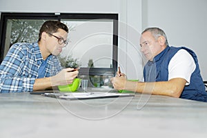 Two men eating soup