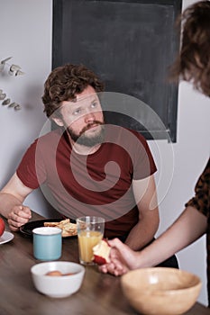 Two men eating together while having a conversation