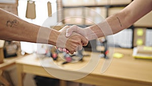 Two men ecommerce business workers shake hands at office