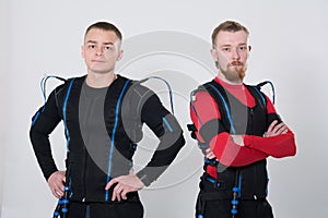 Two men in an electric muscular suit for stimulation.
