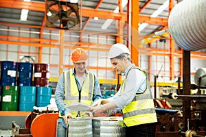 Two men engineer talking in modern factory. Production line machine and setting it for work