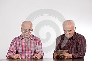 Two men with euro notes and coins