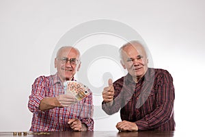 Two men with euro notes s in their hands