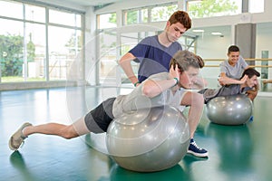 Two men exercising with personal trainers