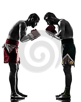 Two men exercising thai boxing salute silhouette