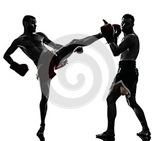 Two men exercising thai boxing silhouette