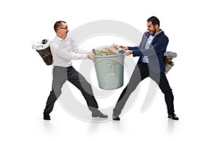 Two men fighting for trash bins isolated over white background. Taking care after planet, cleaning