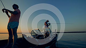 Two men a fishing on a boat in the open water