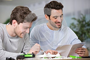 two men fixing drone