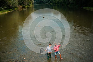 Two men friends fisherman fishing on river. Old father and son with rod fishing at riverside. Recreational activity.