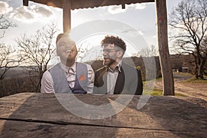 Two men, gay couple portrait outdoors