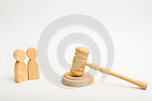 Two men and a hammer of the judge. The trial of cases in court, the resolution of a dispute between two people. Business relations