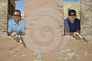 Two Men With Hand Guns At Firing Range