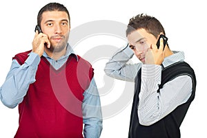 Two men having conversation by phones