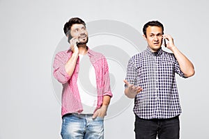 Two men having conversation by phones mobile on white background