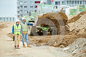 Building inspectors watching excavation process photo