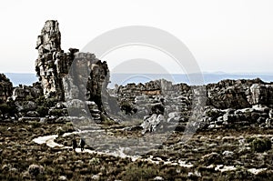 Two men hiking between the rocks photo