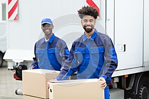 Two Men Holding The Cardboard Boxes