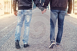 Two men holding hands