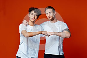 two men hugging friendship communication lifestyle red background