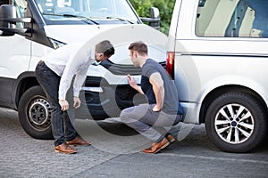 Two Men Inspecting The Car Damaged After Accident