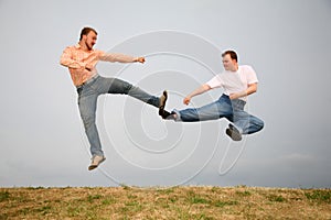 Two men kicking photo