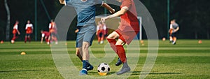 Two Men Kicking Soccer Ball. Junior Teenage Soccer Team on Training Game