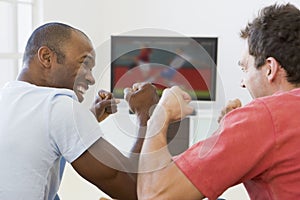 Two men in living room watching television photo