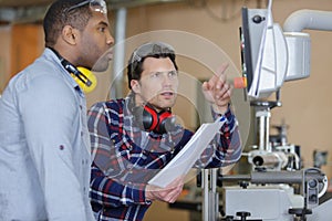 two men looking at computer screen