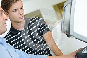 Two men looking at monitor