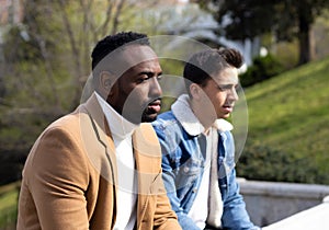 Two men looking serious and pensive. Afro-american and caucasian man