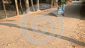 Two men in lungi walking