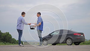 Two men make deal. man handshake seller driver makes car the auto insurance slow motion video sale sells used cars