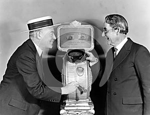 Two men next to a nickelodeon