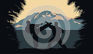Two men occupy karate on a background an ocean and mountains. photo
