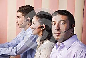 Two men and one women working in office