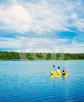 Two Men Paddle a Kayak on Lake. Lifestyle Concept.