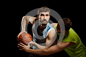 Two men playing basketball