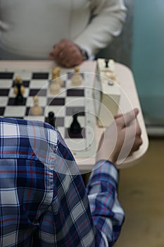 Two men playing chess Pieces on the chessboard chess game chess clock