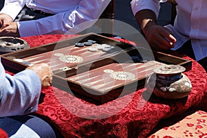 Two men playing a game of backgammon (tavla) in a teahouse